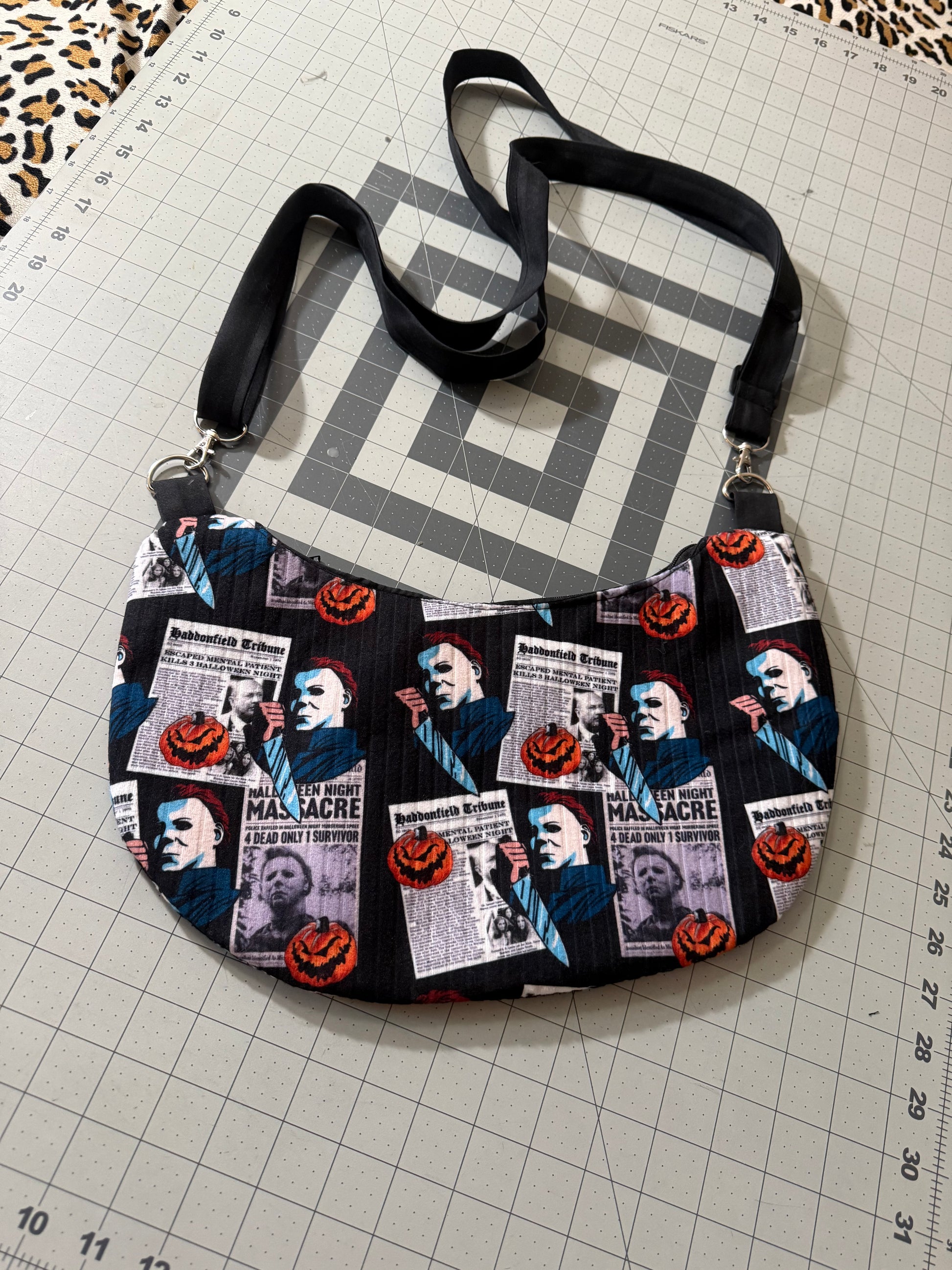 Newspaper K!ller Crescent Crossbody Bag
